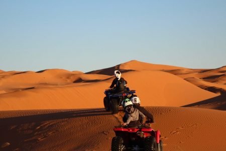 ATV RIDING ON THE DUNES IN THE DESERT